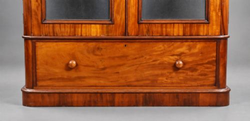 fig 5. A nineteenth-century Victorian mahogany wardrobe featuring two arched mirrored doors above a single full-width drawer with turned wooden knobs.