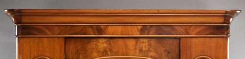 fig 3. Victorian flame mahogany wardrobe featuring a central full-length arched mirror door flanked by arched wood panels, topped with a moulded cornice and resting on a base drawer.
