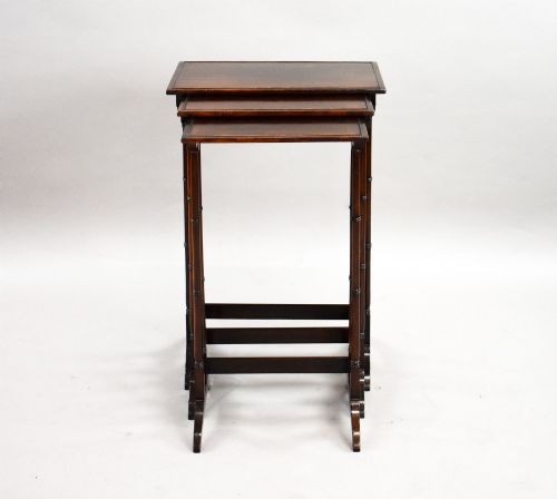 fig 1. An Edwardian nest of three graduating mahogany tables with turned legs and trestle feet.
