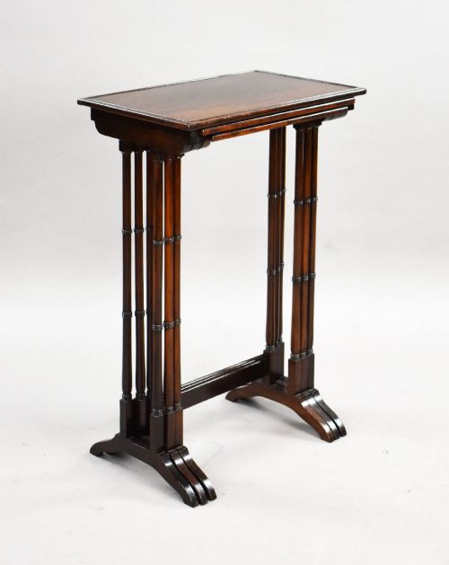 fig 2. An Edwardian nest of three graduating mahogany tables with turned legs and trestle feet.