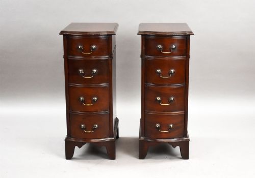 fig 1. A pair of narrow mahogany bow-front bedside chests featuring four drawers each with brass drop handles and bracket feet.