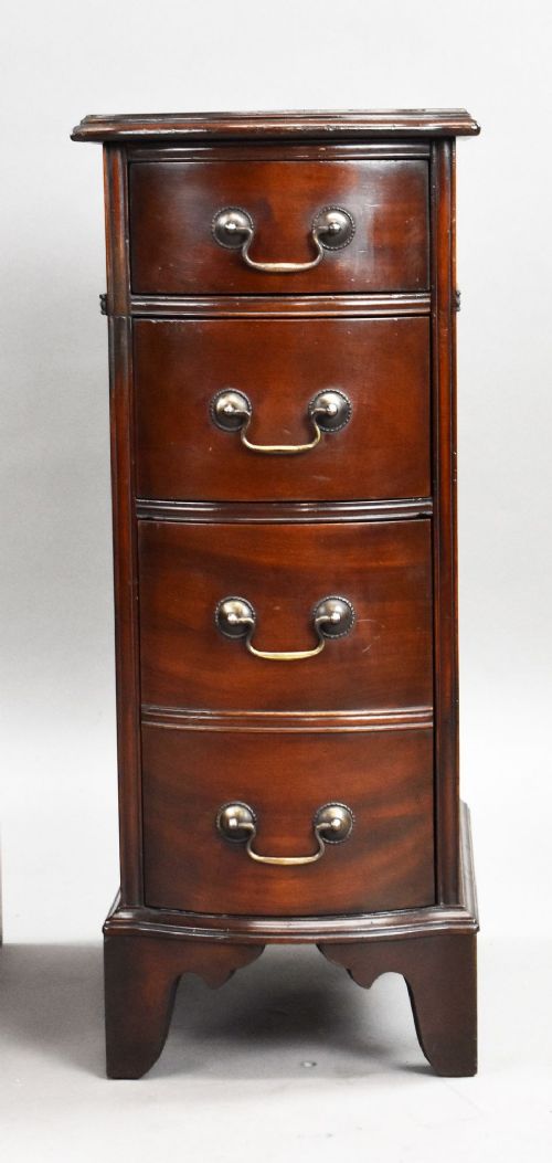 A pair of narrow mahogany bow-front bedside chests featuring four drawers each with brass drop handles and bracket feet. View VI