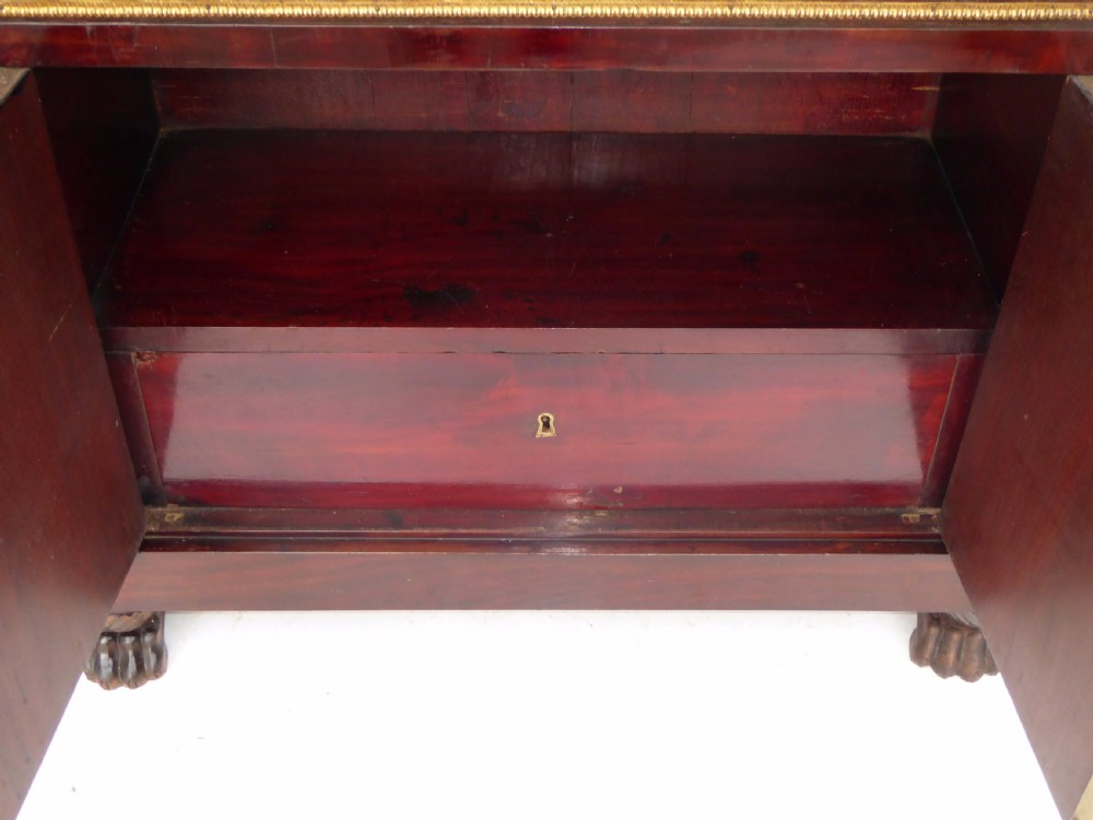 A dark mahogany drop-front escritoire cabinet featuring an open writing flap, fitted interior drawers, brass mounts, a black marble top, and carved paw feet. View XIII
