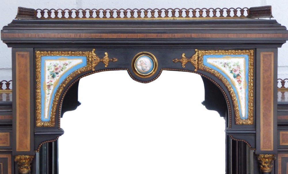 An ebonised and walnut 19th-century Bonheur du Jour writing desk featuring porcelain plaque inserts, gilded mounts, mirrors, and lower tier shelves. View III