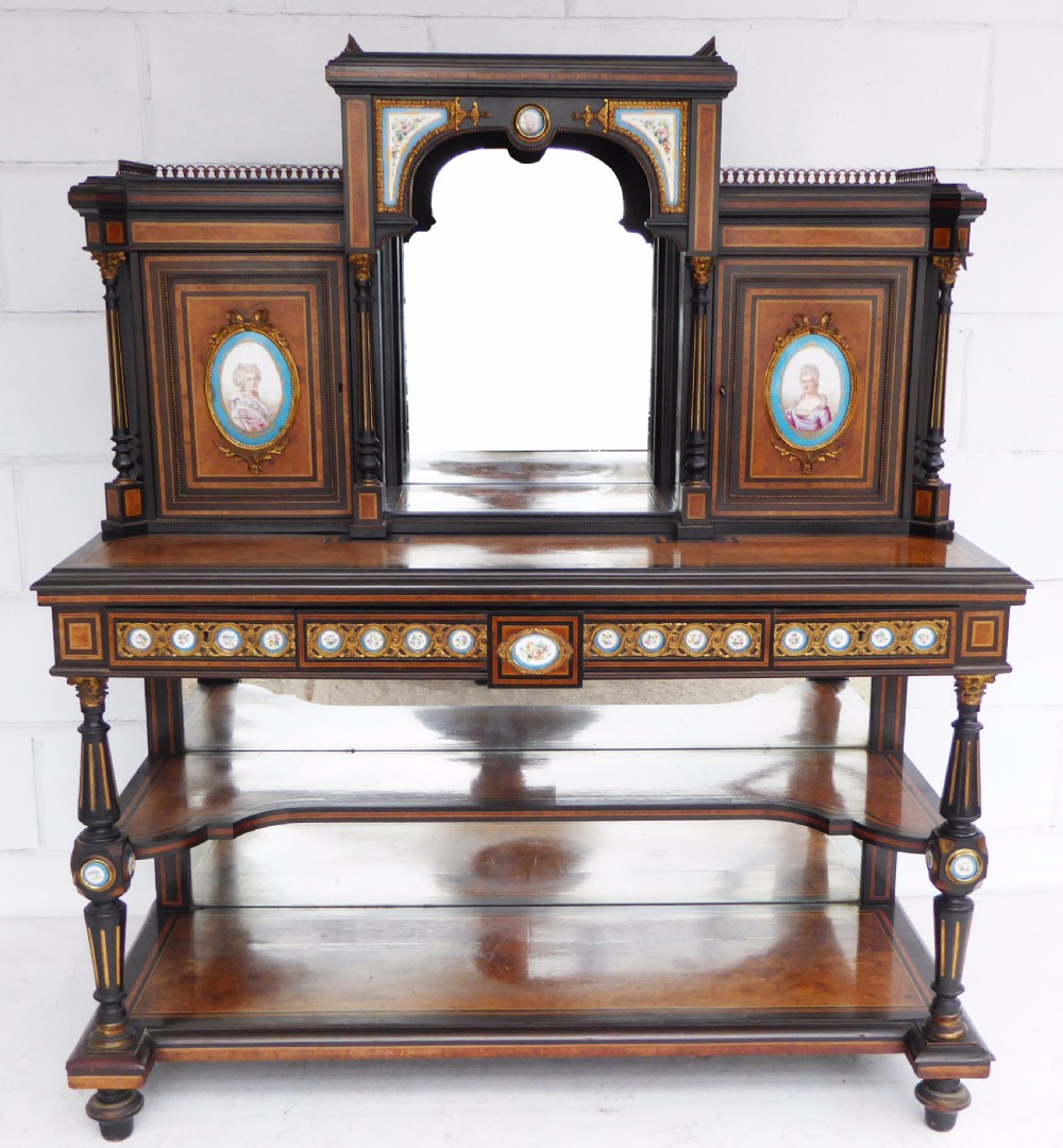 An ebonised and walnut 19th-century Bonheur du Jour writing desk featuring porcelain plaque inserts, gilded mounts, mirrors, and lower tier shelves. View V