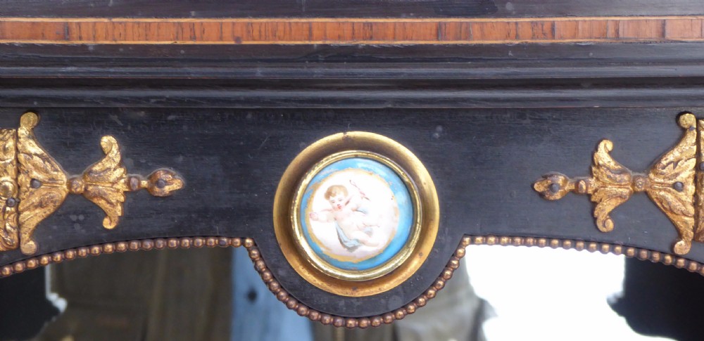 An ebonised and walnut 19th-century Bonheur du Jour writing desk featuring porcelain plaque inserts, gilded mounts, mirrors, and lower tier shelves. View VIII