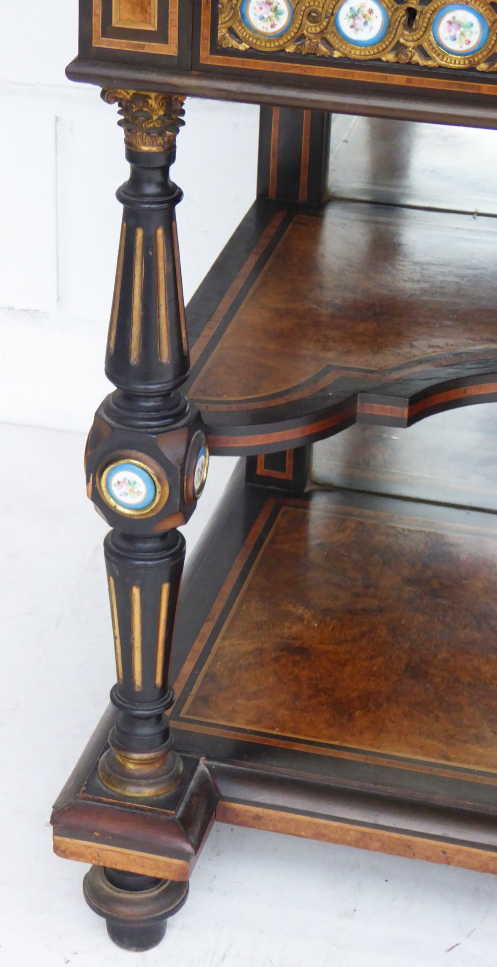 An ebonised and walnut 19th-century Bonheur du Jour writing desk featuring porcelain plaque inserts, gilded mounts, mirrors, and lower tier shelves. View XI