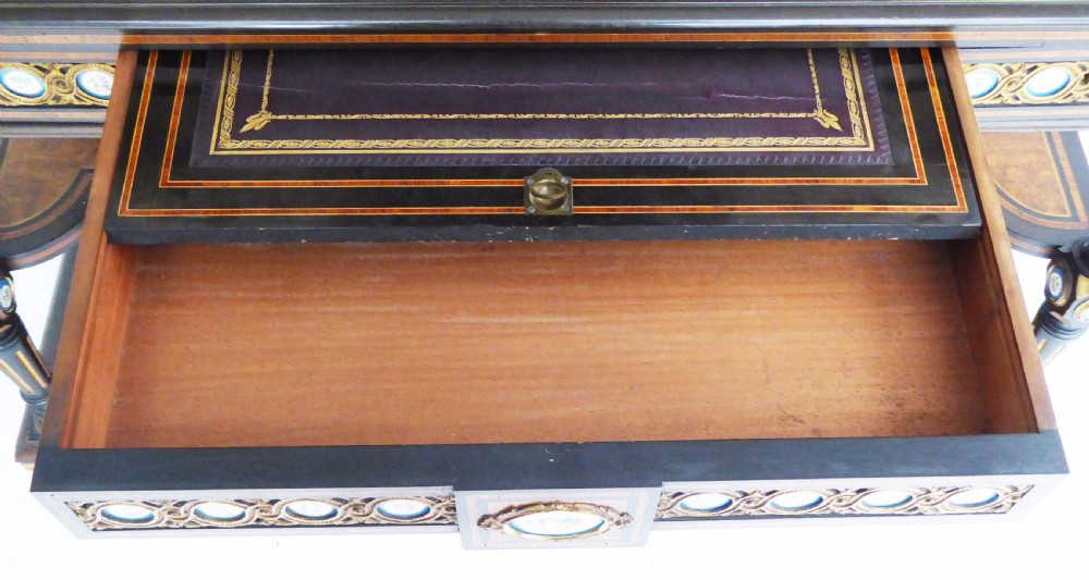 An ebonised and walnut 19th-century Bonheur du Jour writing desk featuring porcelain plaque inserts, gilded mounts, mirrors, and lower tier shelves. View XVI