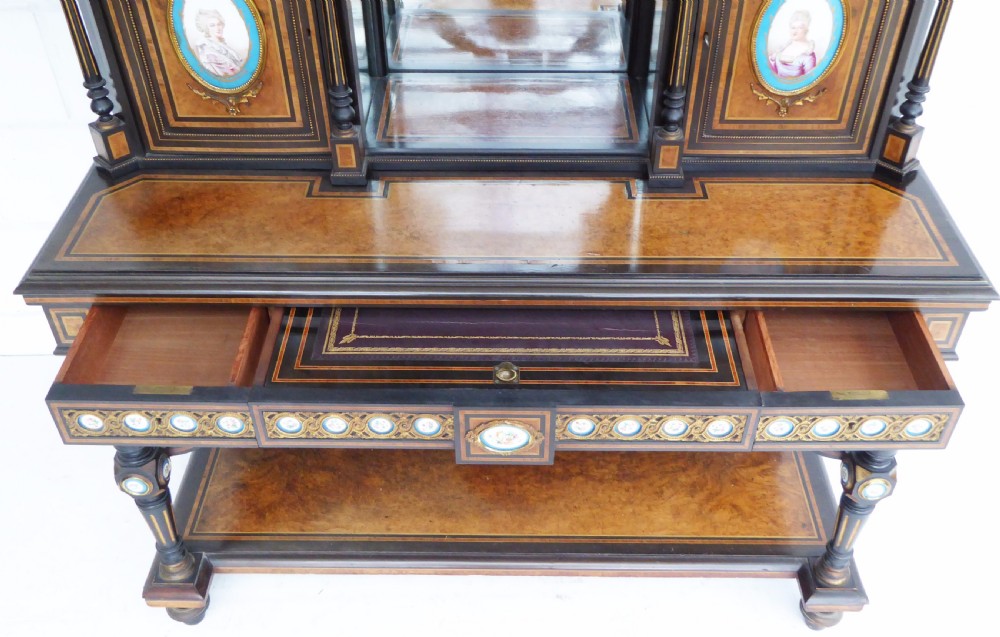 An ebonised and walnut 19th-century Bonheur du Jour writing desk featuring porcelain plaque inserts, gilded mounts, mirrors, and lower tier shelves. View XVII