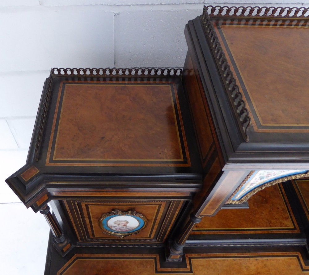 An ebonised and walnut 19th-century Bonheur du Jour writing desk featuring porcelain plaque inserts, gilded mounts, mirrors, and lower tier shelves. View XXI