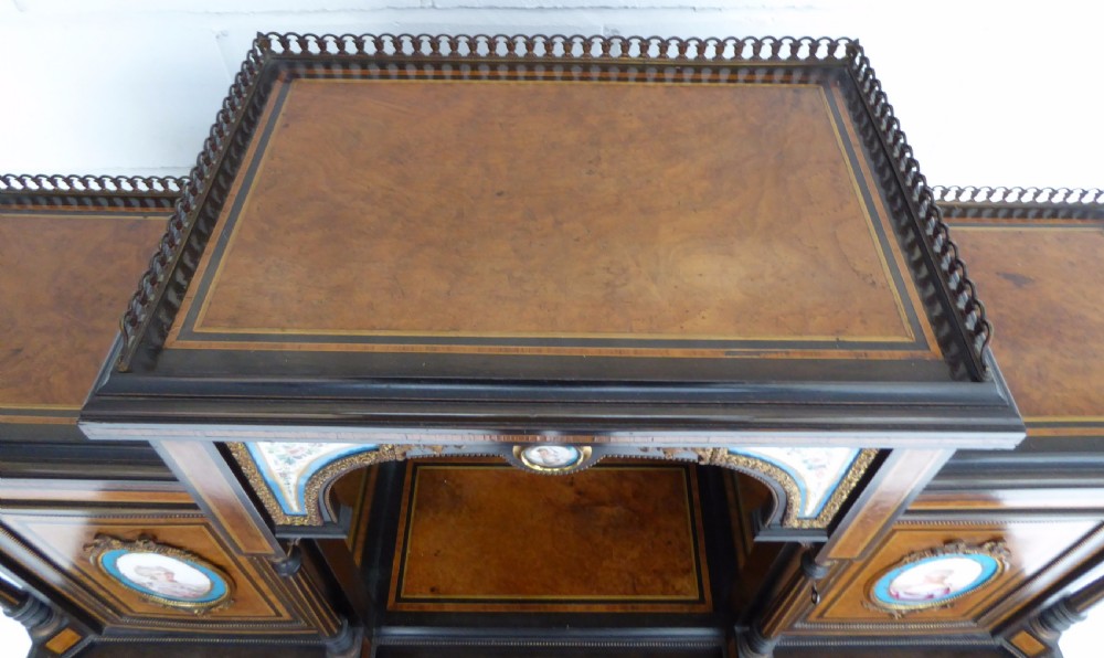 An ebonised and walnut 19th-century Bonheur du Jour writing desk featuring porcelain plaque inserts, gilded mounts, mirrors, and lower tier shelves. View XXII
