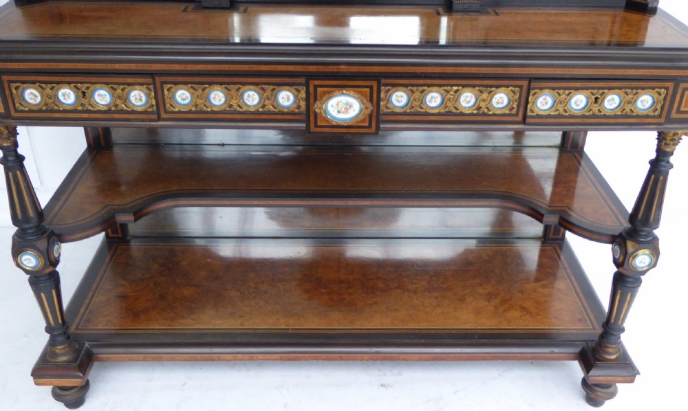 An ebonised and walnut 19th-century Bonheur du Jour writing desk featuring porcelain plaque inserts, gilded mounts, mirrors, and lower tier shelves. View XXIV