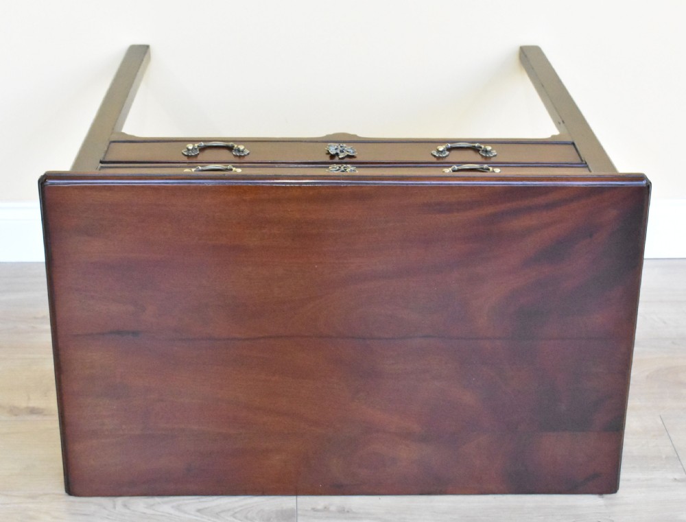 A George III mahogany side table featuring two drawers with brass swan-neck handles and decorative keyhole escutcheons, supported on straight square legs. View VII