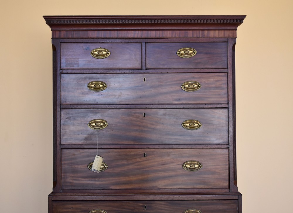 A George III mahogany chest-on-chest featuring a dentil-moulded cornice, fluted chamfered corners, brass oval handles, and bracket feet. View III
