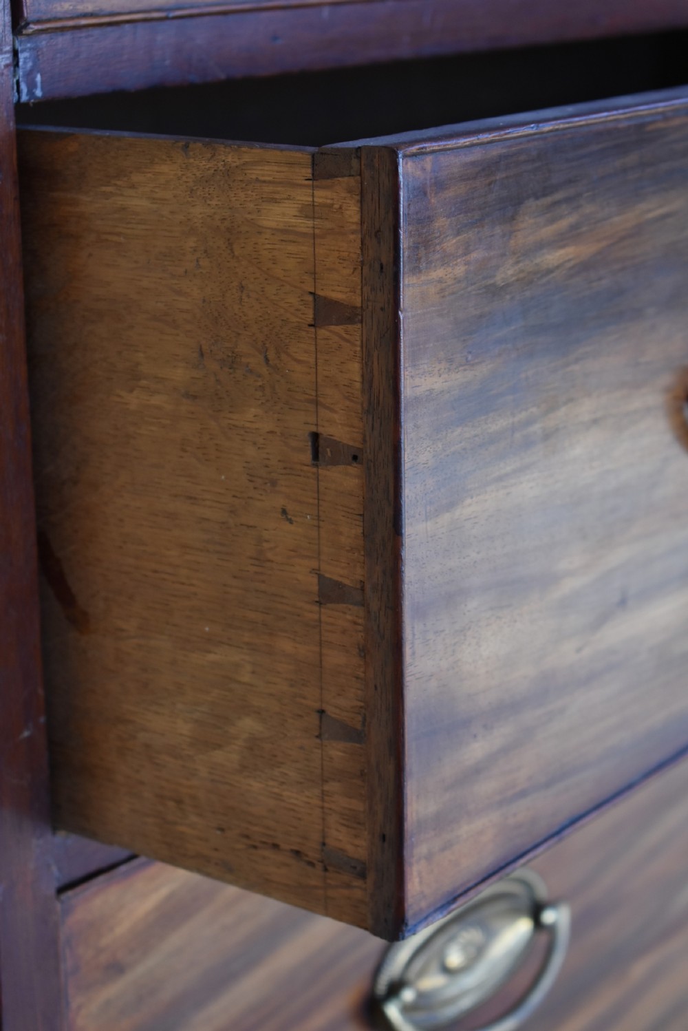 A George III mahogany chest-on-chest featuring a dentil-moulded cornice, fluted chamfered corners, brass oval handles, and bracket feet. View IV