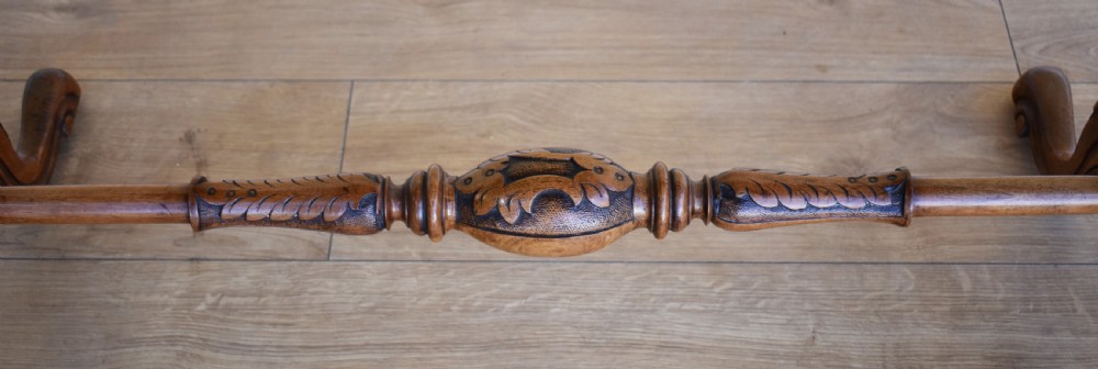 An oval Victorian burr walnut occasional table featuring carved turned uprights, a decorative stretcher, and carved cabriole legs. View III