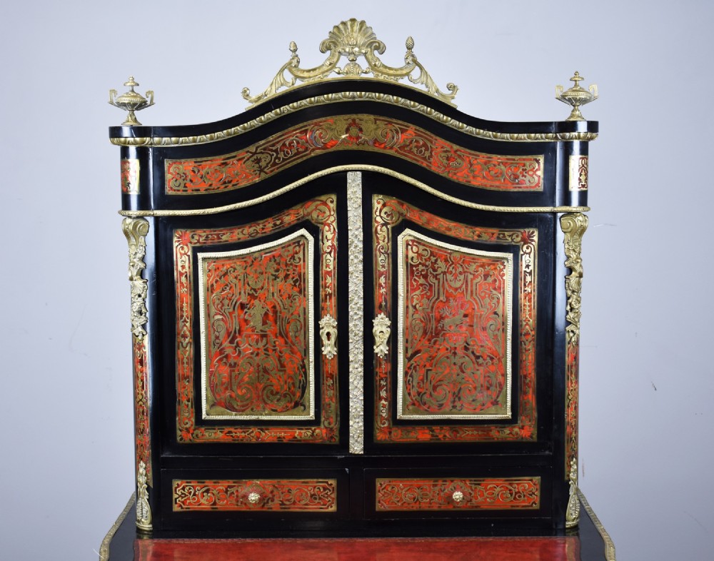 A 19th-century ebonised French bonheur du jour writing desk featuring red tortoiseshell and brass Boulle marquetry, cabriole legs, and gilt-bronze mounts. View III