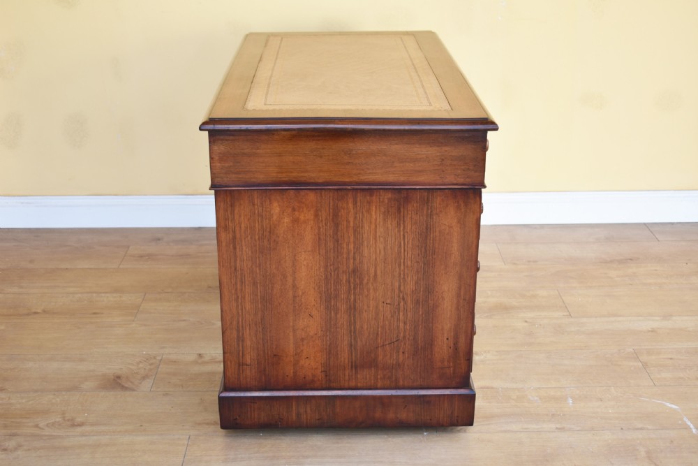 A nineteenth-century Victorian pedestal desk crafted from burr walnut featuring nine drawers with turned wooden handles and a leather writing top. View VII