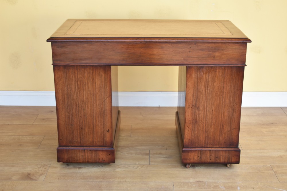 A nineteenth-century Victorian pedestal desk crafted from burr walnut featuring nine drawers with turned wooden handles and a leather writing top. View VIII