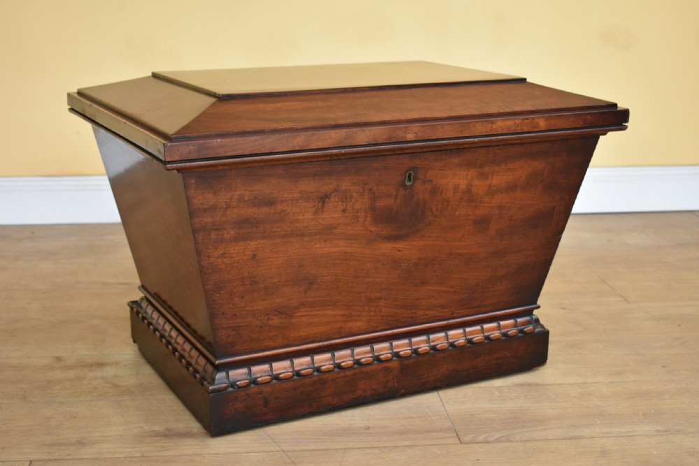 A 19th-century William IV sarcophagus-shaped mahogany wine cooler with a stepped lid and gadrooned plinth base.