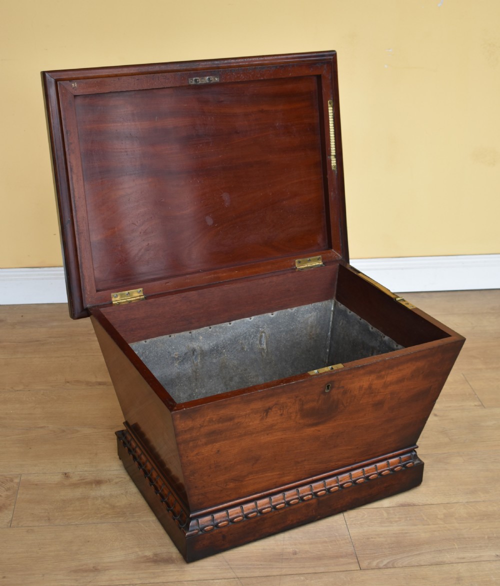 A 19th-century William IV sarcophagus-shaped mahogany wine cooler with a stepped lid and gadrooned plinth base. View II