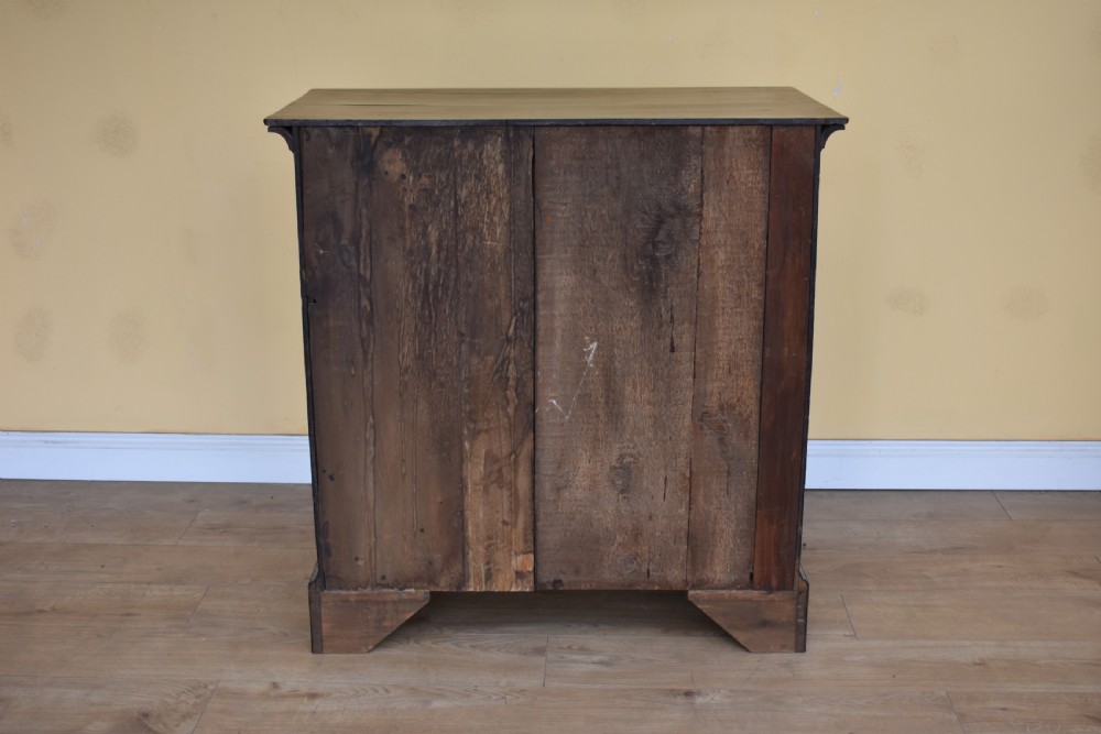 An 18th-century George III oak chest of drawers featuring a two over three drawer arrangement with brass handles and bracket feet. View VI