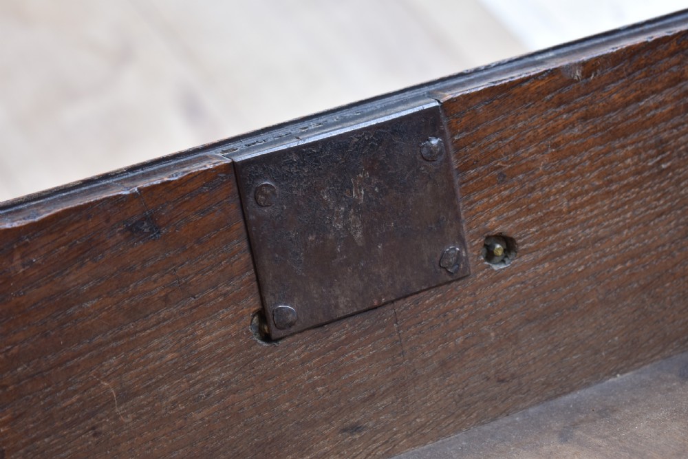 An 18th-century George III oak chest of drawers featuring a two over three drawer arrangement with brass handles and bracket feet. View IX