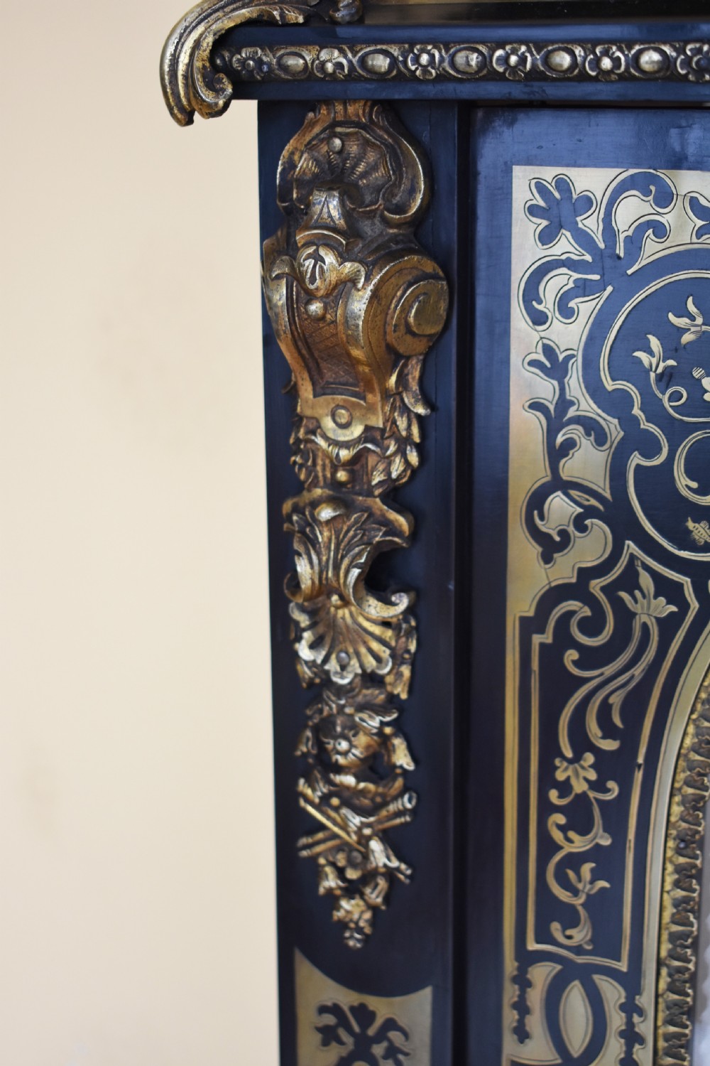 A pair of 19th-century ebonised display cabinets decorated with intricate brass Boulle marquetry, glazed arched doors, and gilt-bronze mounts. View VI