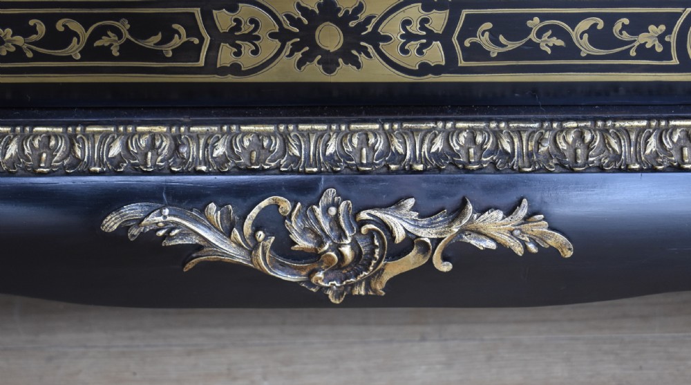 A pair of 19th-century ebonised display cabinets decorated with intricate brass Boulle marquetry, glazed arched doors, and gilt-bronze mounts. View VII
