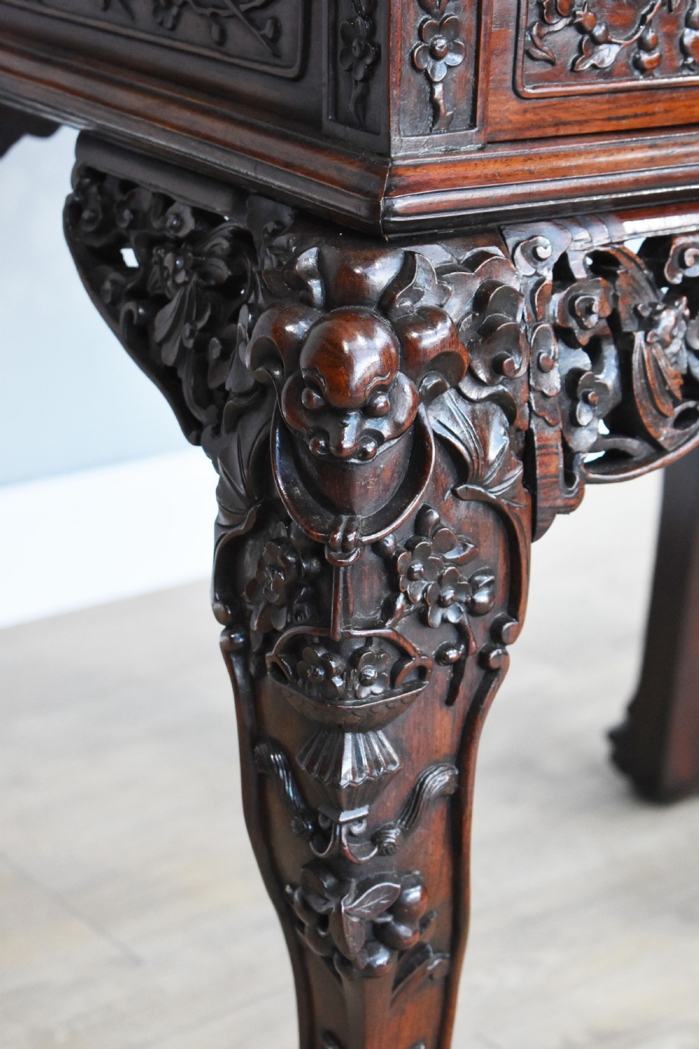 A 19th-century Chinese carved padouk wood desk featuring an intricate openwork gallery superstructure, frieze drawers, and cabriole legs ending in claw feet. View IX