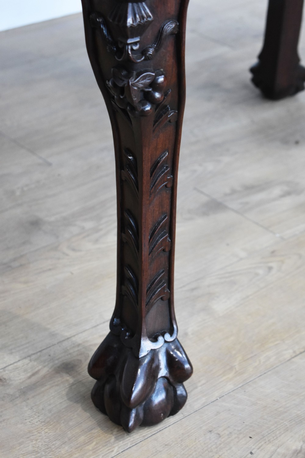 A 19th-century Chinese carved padouk wood desk featuring an intricate openwork gallery superstructure, frieze drawers, and cabriole legs ending in claw feet. View X
