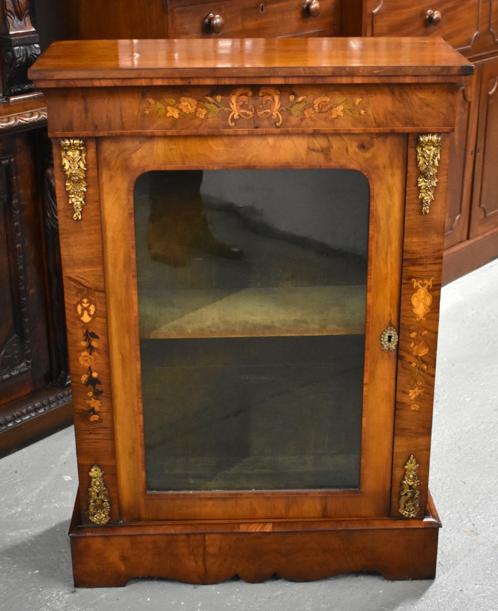 A Victorian walnut pier cabinet with a single glazed door, floral marquetry inlay, and gilt ormolu mounts. View II