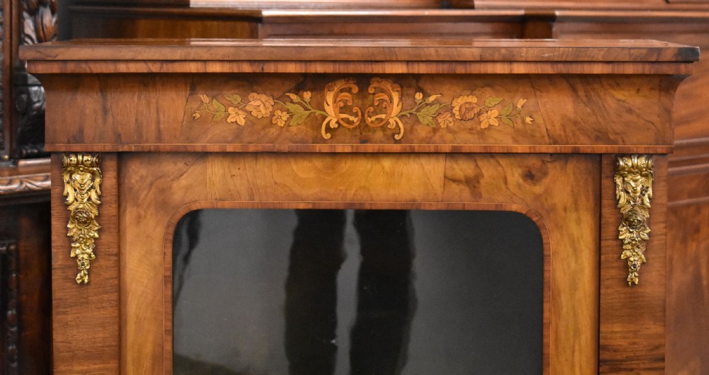 A Victorian walnut pier cabinet with a single glazed door, floral marquetry inlay, and gilt ormolu mounts. View III