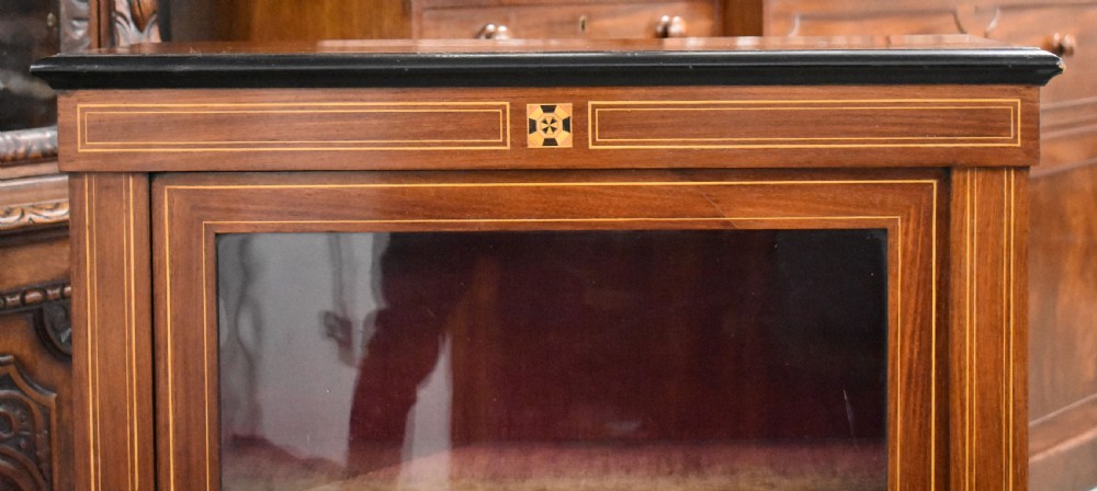 Victorian mahogany pier cabinet with a single glazed door, satinwood inlay borders, and turned black feet. View II