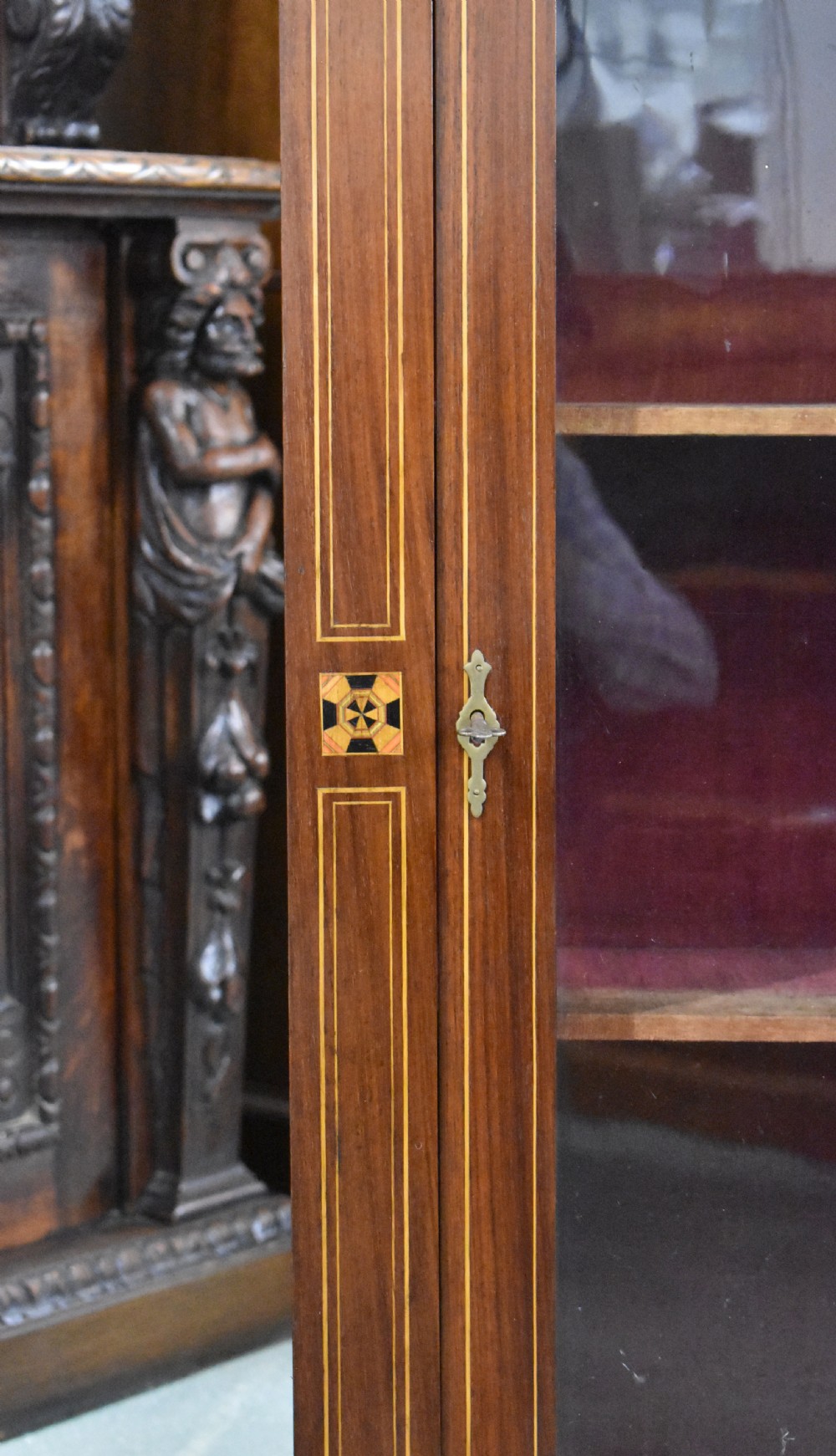 Victorian mahogany pier cabinet with a single glazed door, satinwood inlay borders, and turned black feet. View III