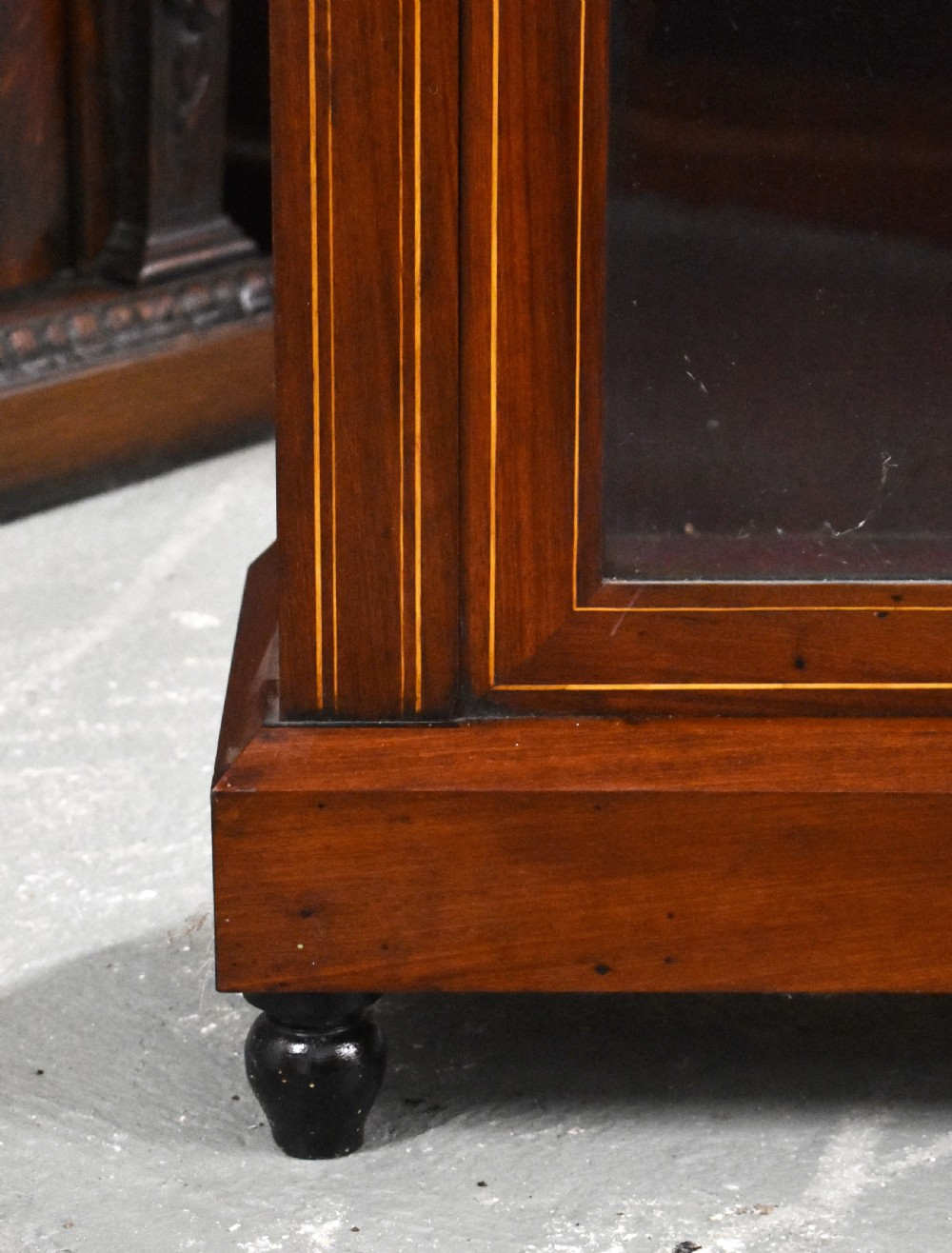 Victorian mahogany pier cabinet with a single glazed door, satinwood inlay borders, and turned black feet. View IV