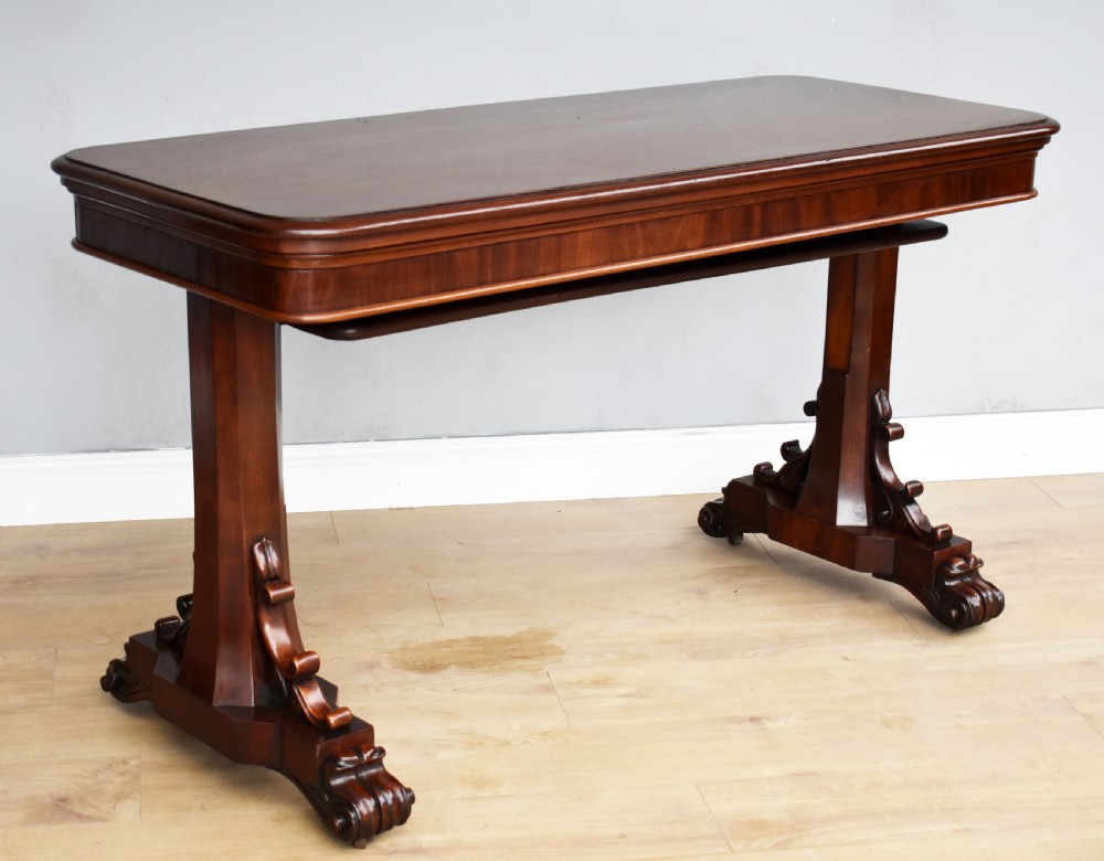 A Victorian mahogany telescopic dumbwaiter with a rectangular top, flame mahogany apron, and carved trestle feet.