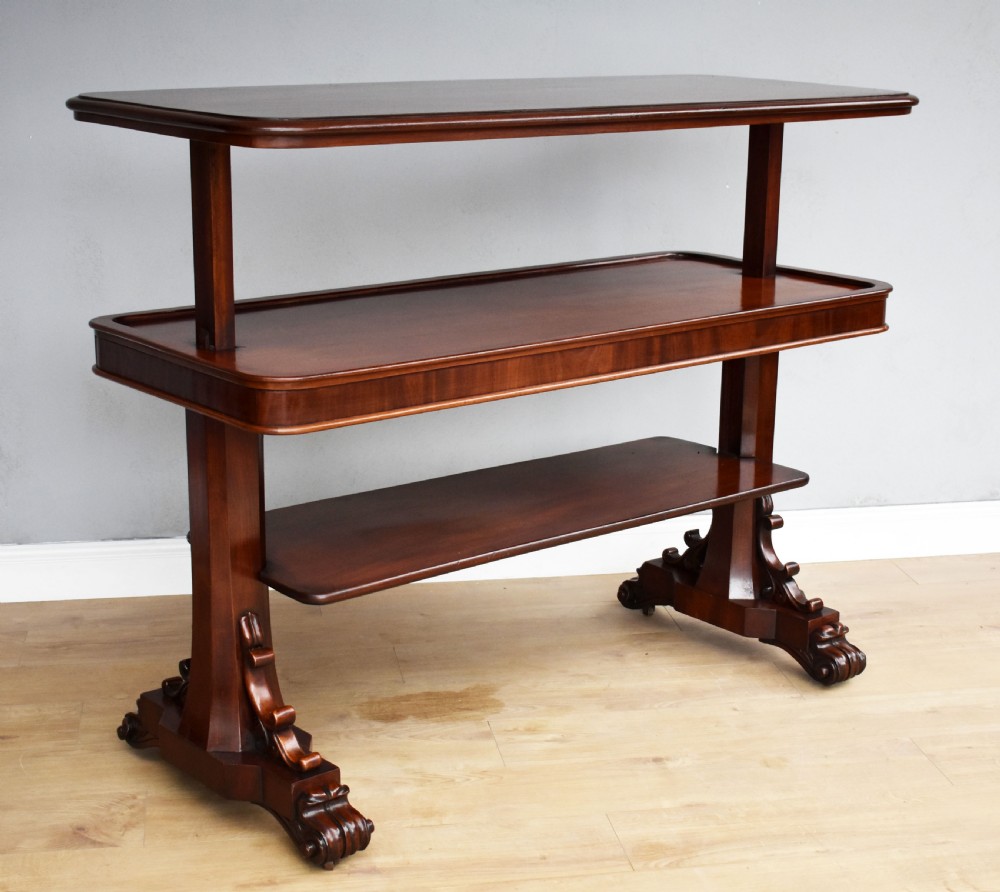 A Victorian mahogany telescopic dumbwaiter with a rectangular top, flame mahogany apron, and carved trestle feet. View III