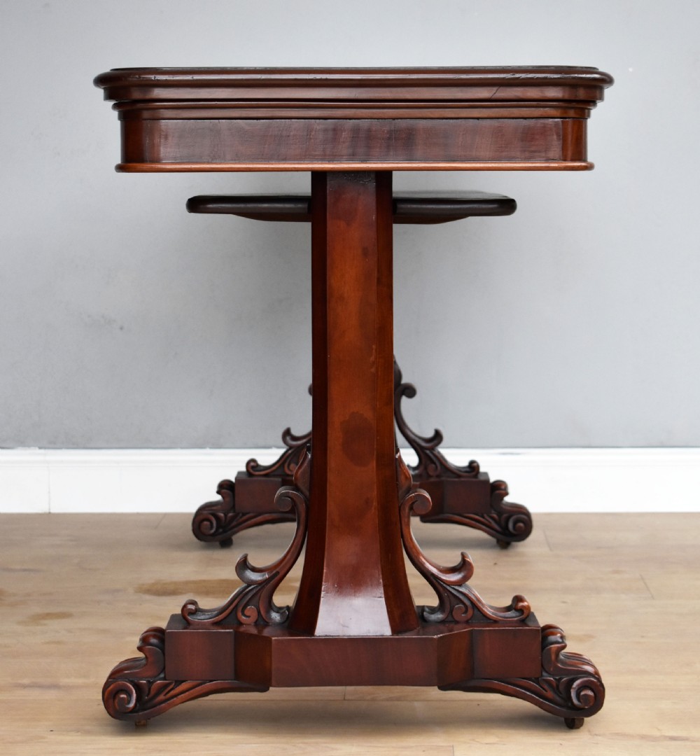 A Victorian mahogany telescopic dumbwaiter with a rectangular top, flame mahogany apron, and carved trestle feet. View V