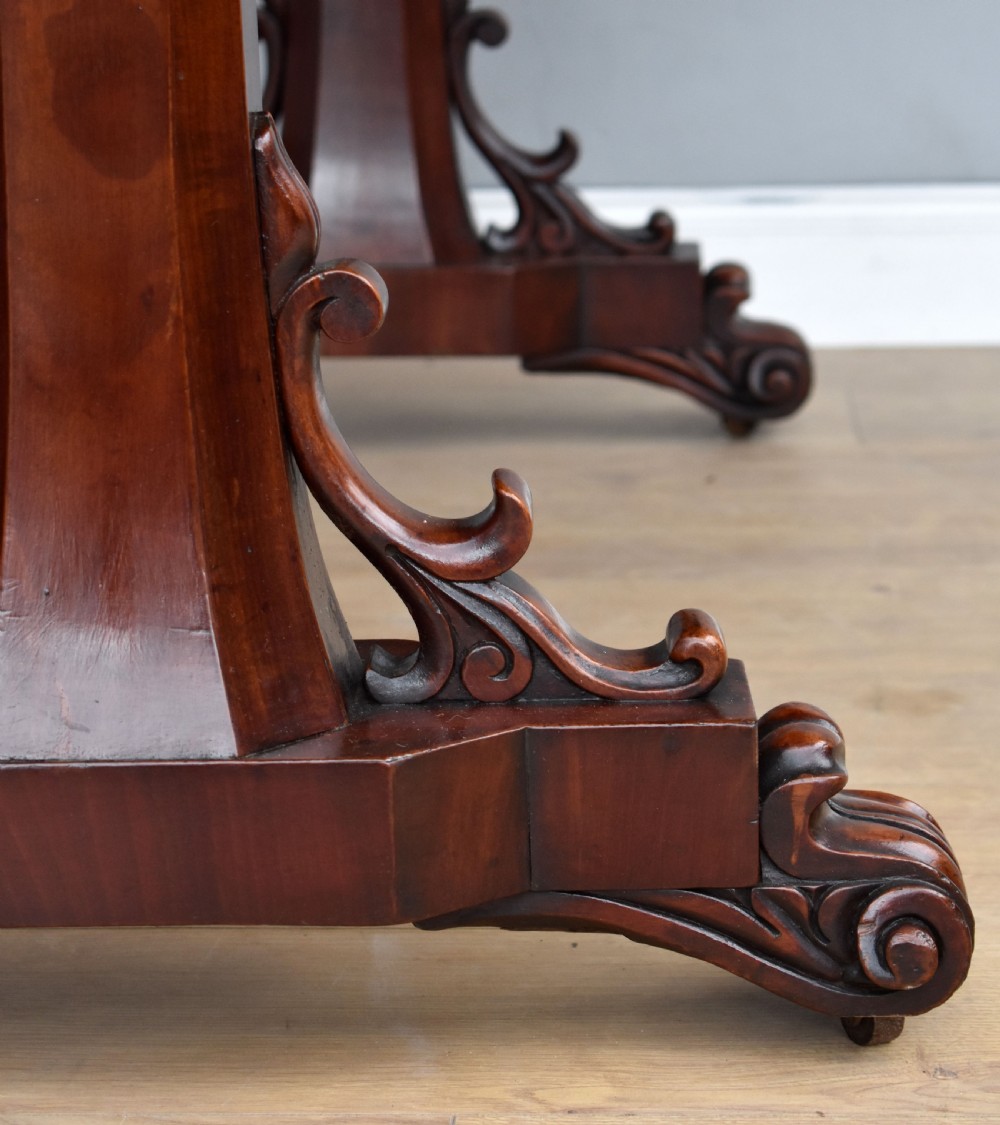 A Victorian mahogany telescopic dumbwaiter with a rectangular top, flame mahogany apron, and carved trestle feet. View VI