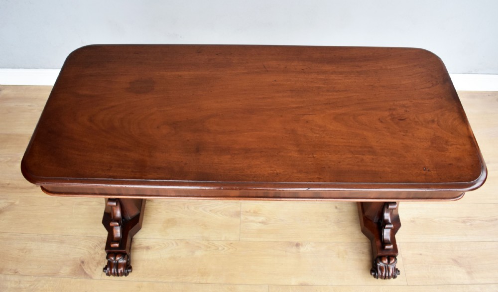 A Victorian mahogany telescopic dumbwaiter with a rectangular top, flame mahogany apron, and carved trestle feet. View VIII