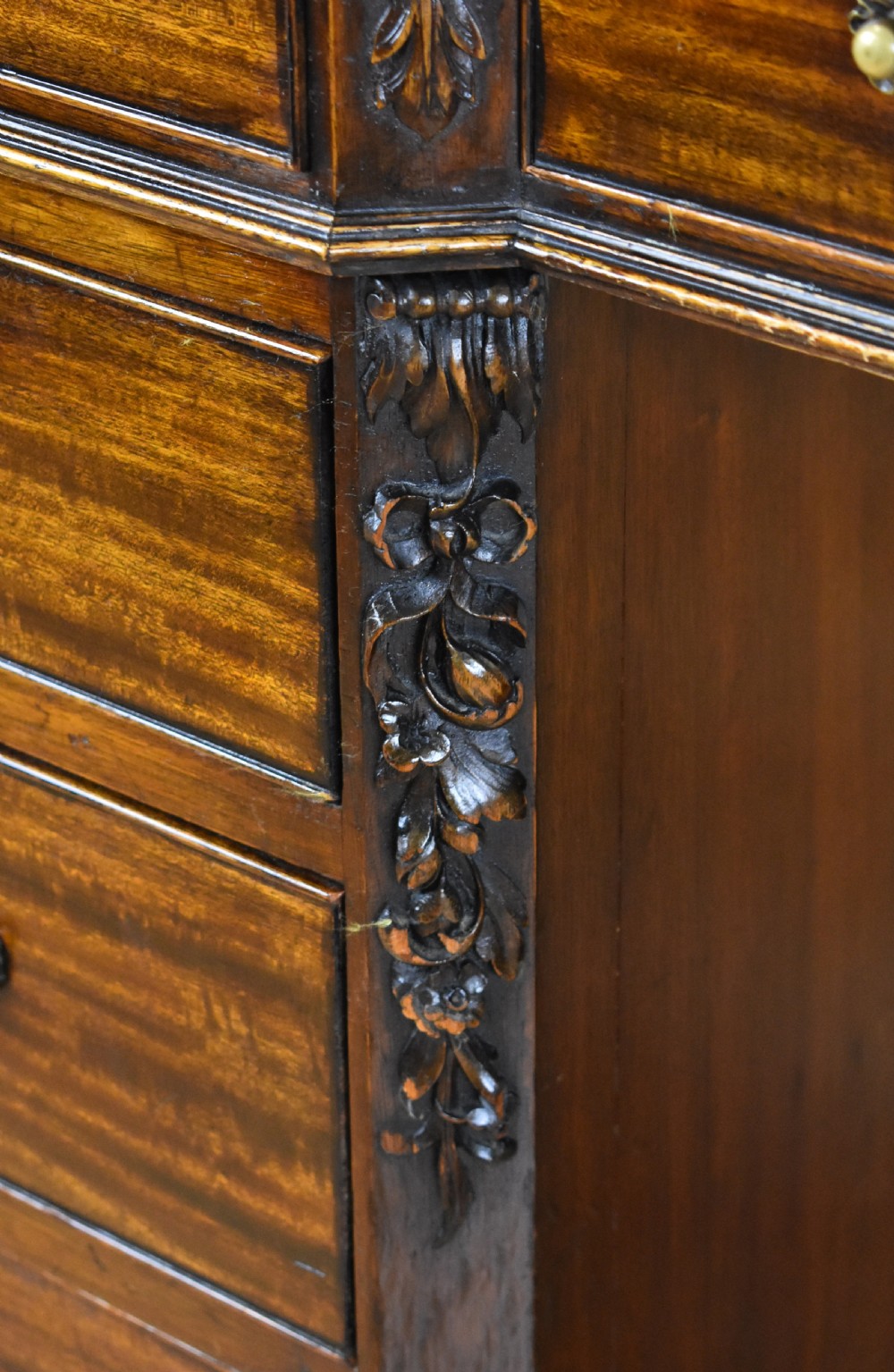 A 19th-century Chippendale style mahogany pedestal desk with a three-section leather inset top, nine drawers, brass handles, and carved pilasters. View XIII