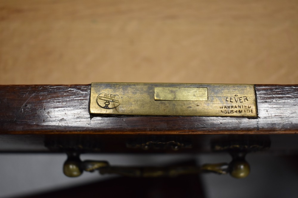 A 19th-century Chippendale style mahogany pedestal desk with a three-section leather inset top, nine drawers, brass handles, and carved pilasters. View XIV