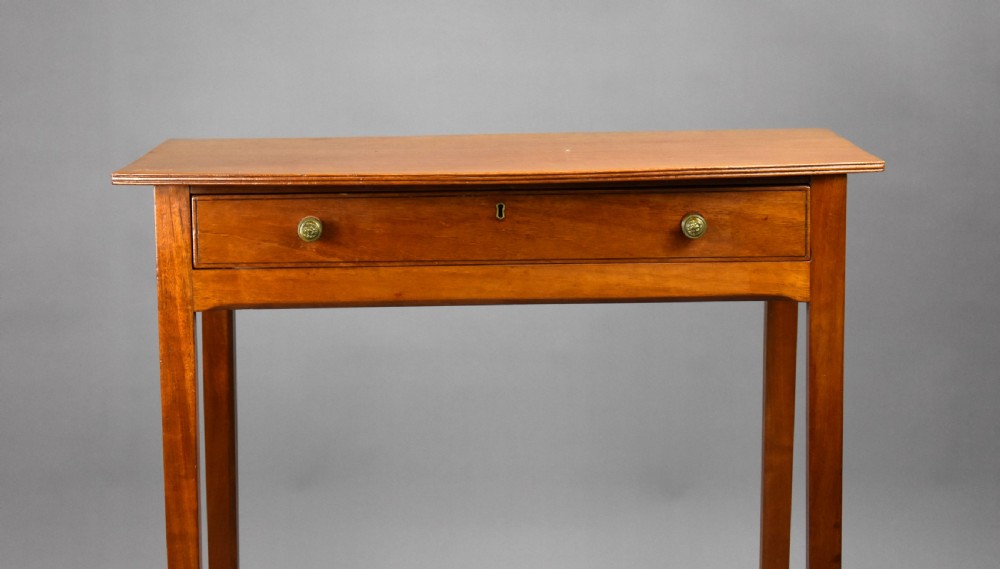 A 19th-century mahogany side table featuring a single drawer with brass knobs and tall, square tapered legs. View III