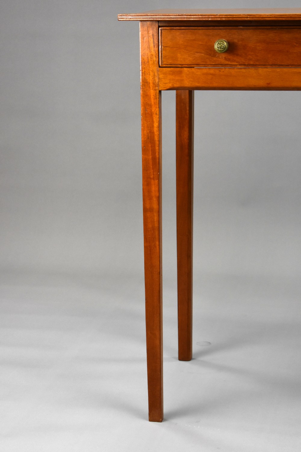 A 19th-century mahogany side table featuring a single drawer with brass knobs and tall, square tapered legs. View IV