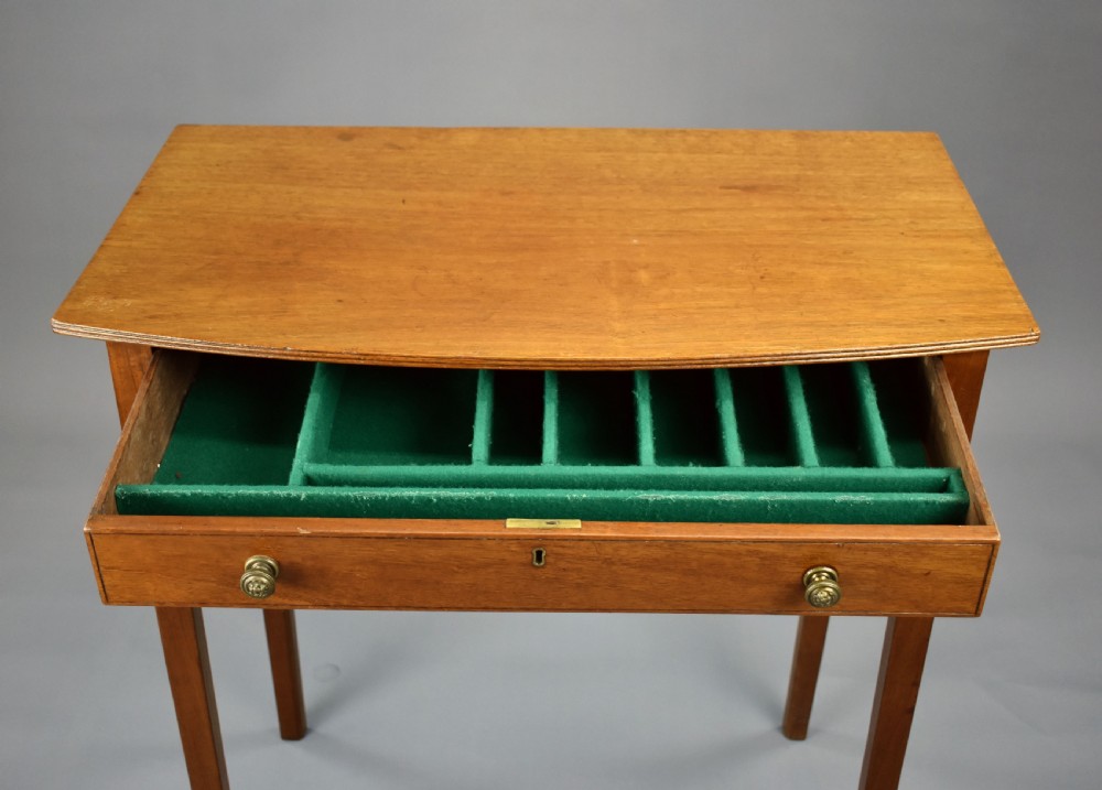 A 19th-century mahogany side table featuring a single drawer with brass knobs and tall, square tapered legs. View VI