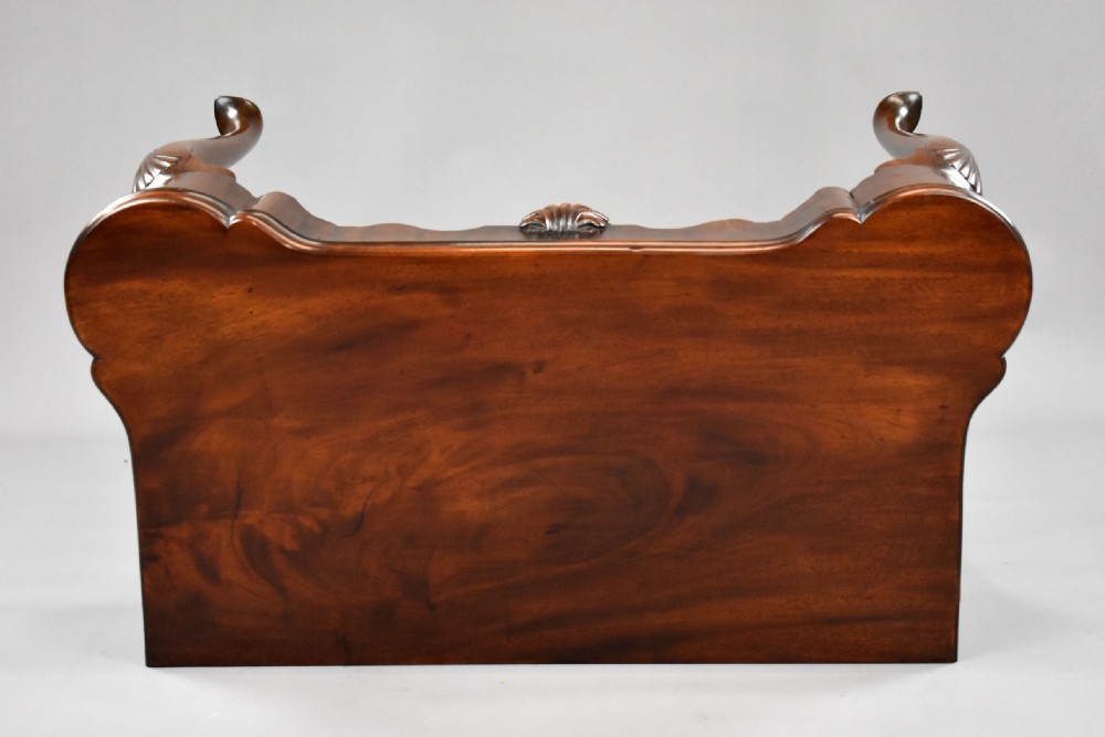 An 18th-century George II Irish mahogany fold-over card table with carved shell knees, a scalloped apron, and slender cabriole legs. View XVIII