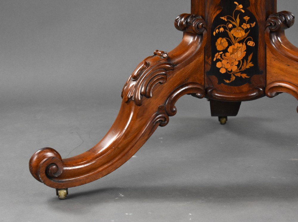 A Victorian burr walnut tilt-top breakfast table featuring a scalloped edge, intricate floral marquetry inlay border, and a carved four-star pedestal base. View XII