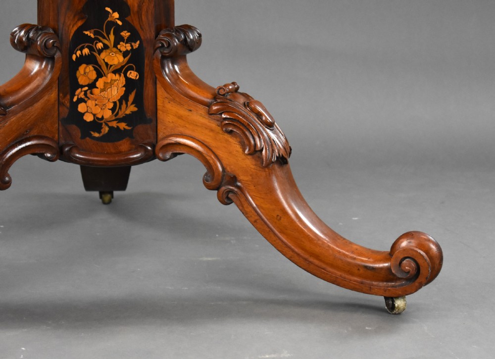 A Victorian burr walnut tilt-top breakfast table featuring a scalloped edge, intricate floral marquetry inlay border, and a carved four-star pedestal base. View XIII