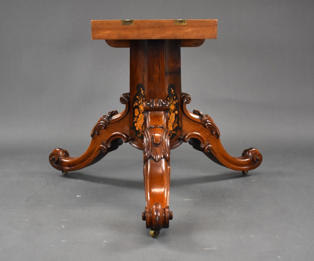 A Victorian burr walnut tilt-top breakfast table featuring a scalloped edge, intricate floral marquetry inlay border, and a carved four-star pedestal base. View XVII